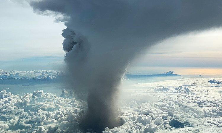 Taal Volcano Eruption - A pillar of smoke pushing through and above the clouds.